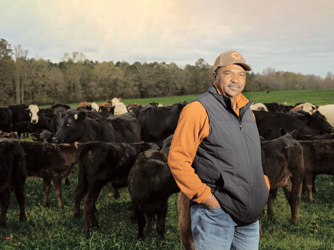 Butch standing in front of cattle